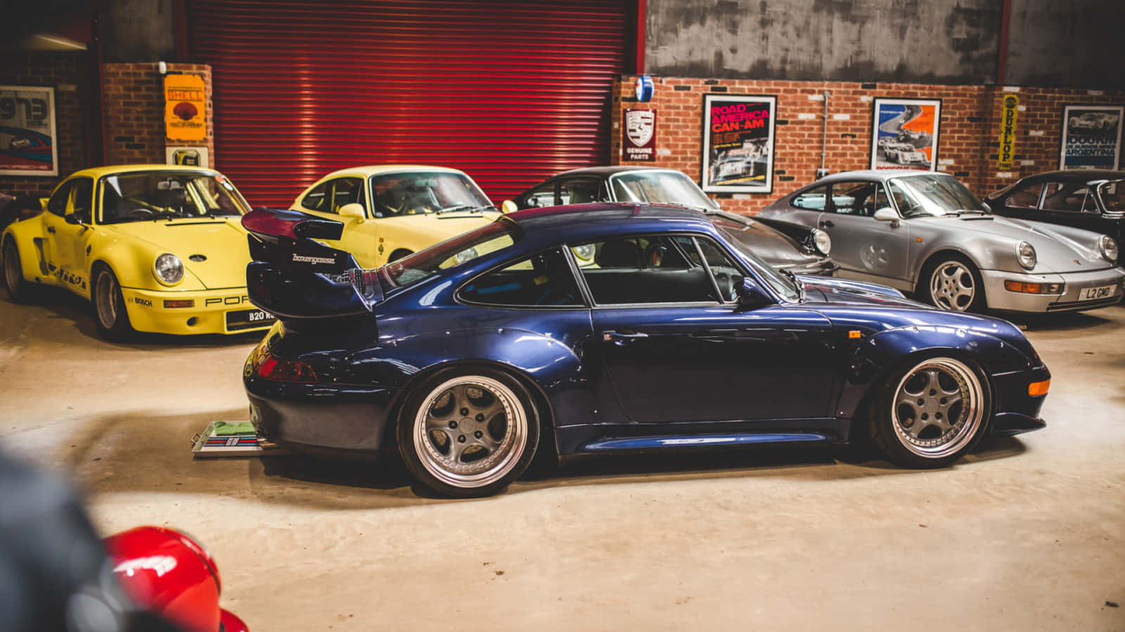 Classic Elegance: A Vibrant Porsche 993 On Display Wallpaper