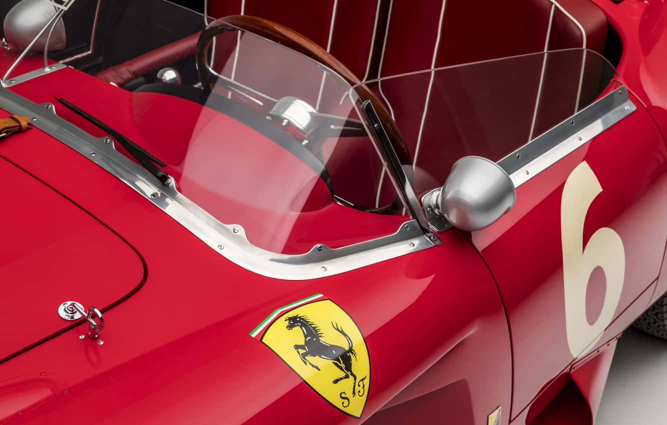 A Classic Ferrari Racing Through The Streets Wallpaper