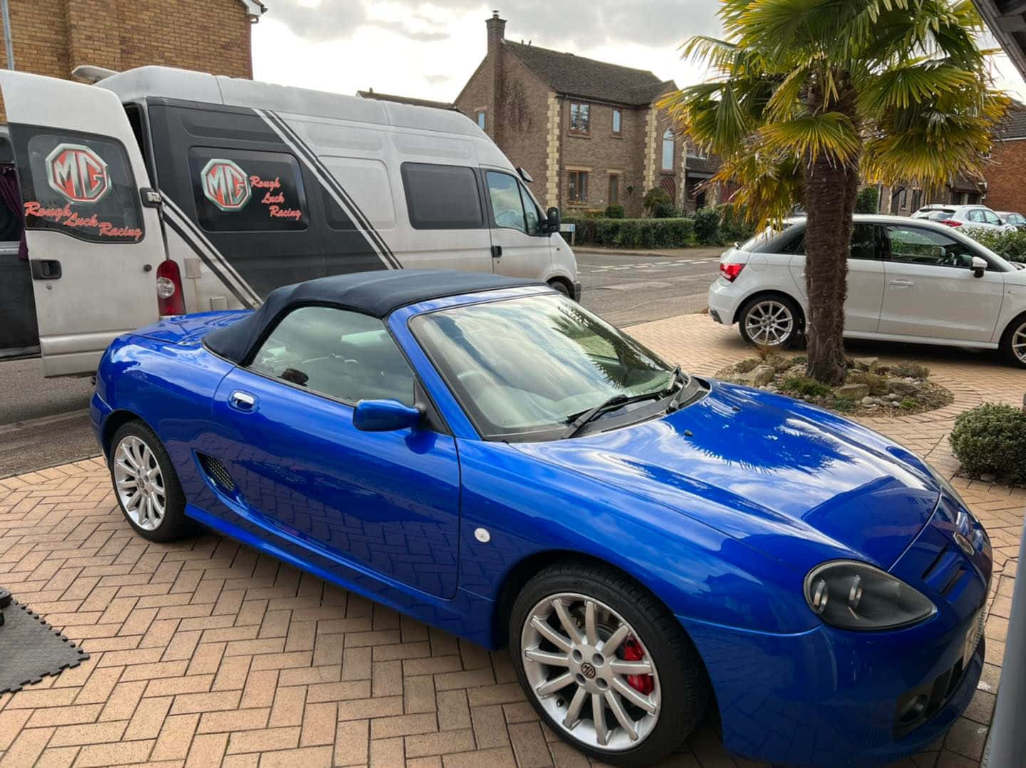 Classic Mg Tf Convertible On A Scenic Road Wallpaper