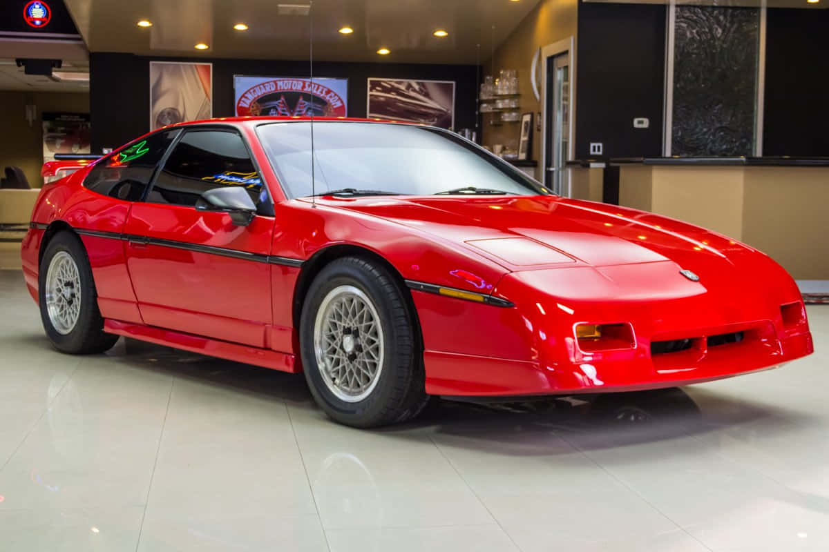 Classic Pontiac Fiero Under The Golden Sunset Wallpaper