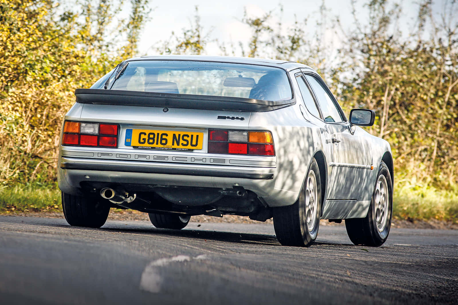 Classic Porsche 944 Gleaming Under Bright Sunlight Wallpaper