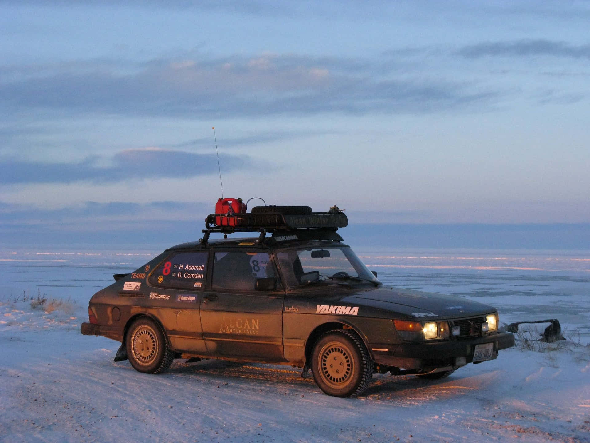 Classic Saab 900 Cruising On An Open Road Wallpaper