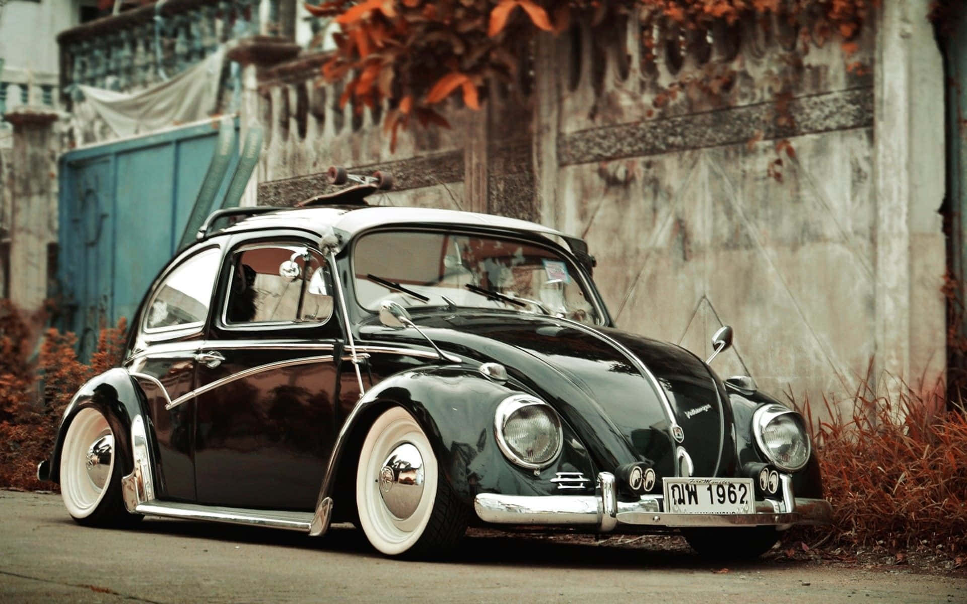 Classic Volkswagen Beetle On A Picturesque Road Wallpaper