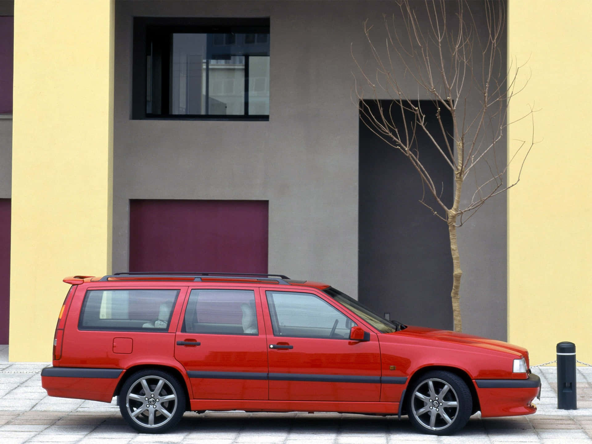 Classic Volvo 850 Gliding Across The Road Wallpaper