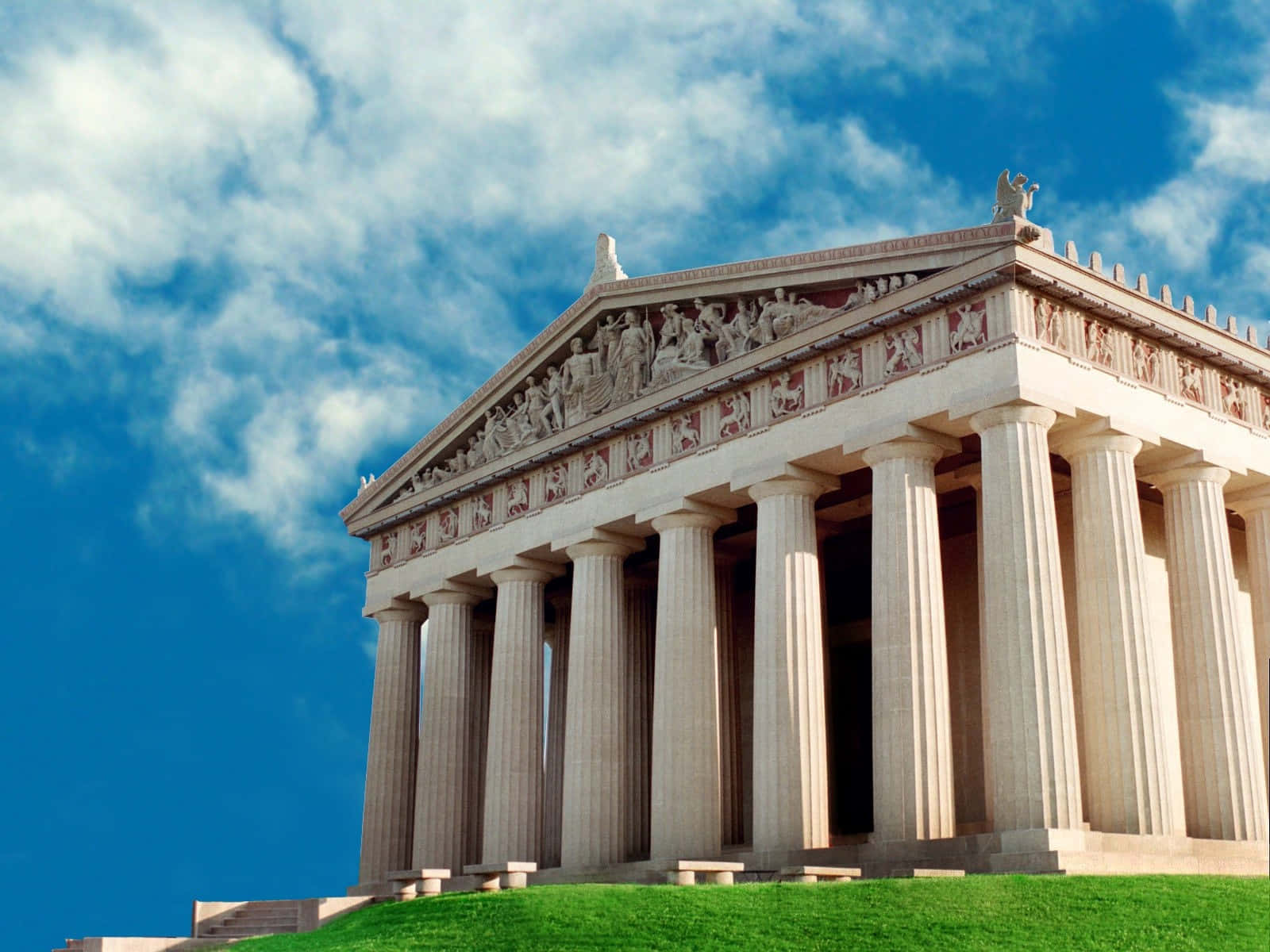 A majestic view of a classical painted building atop a hill