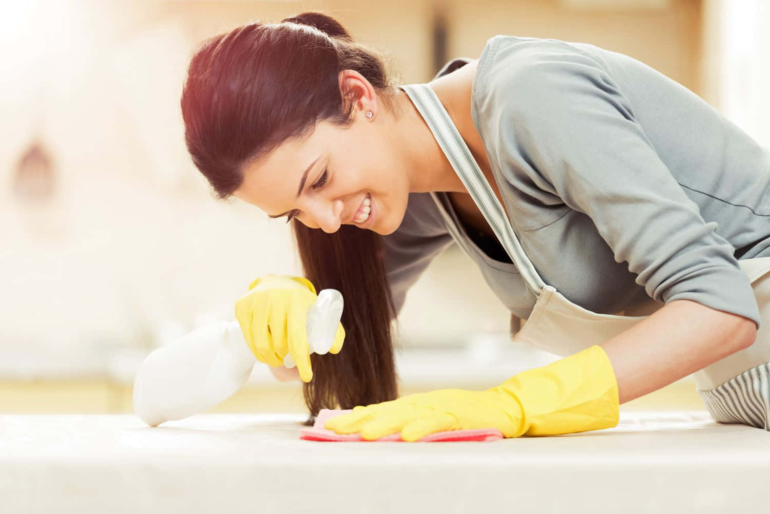 A Woman Cleaning A Table With A Mop