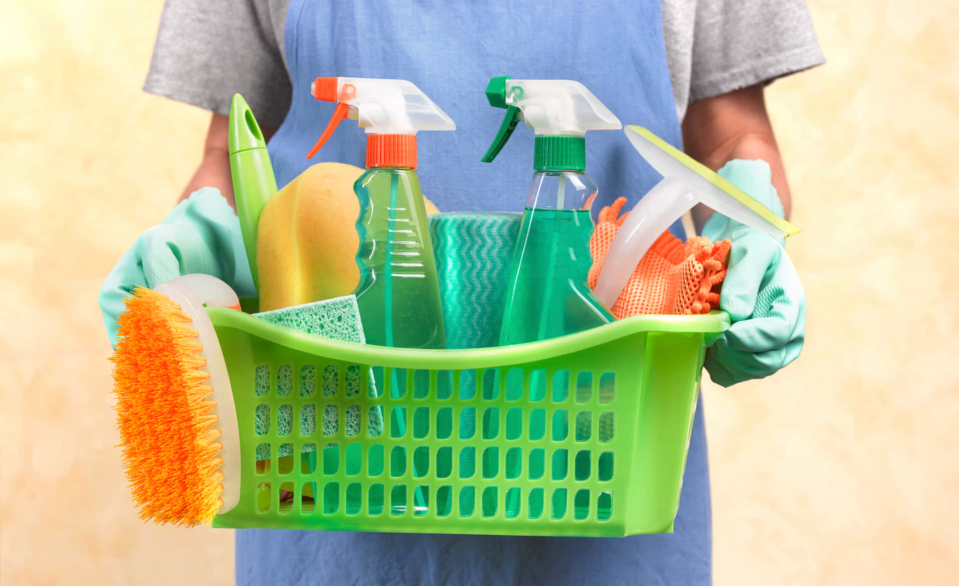 A Man Holding A Basket Of Cleaning Supplies