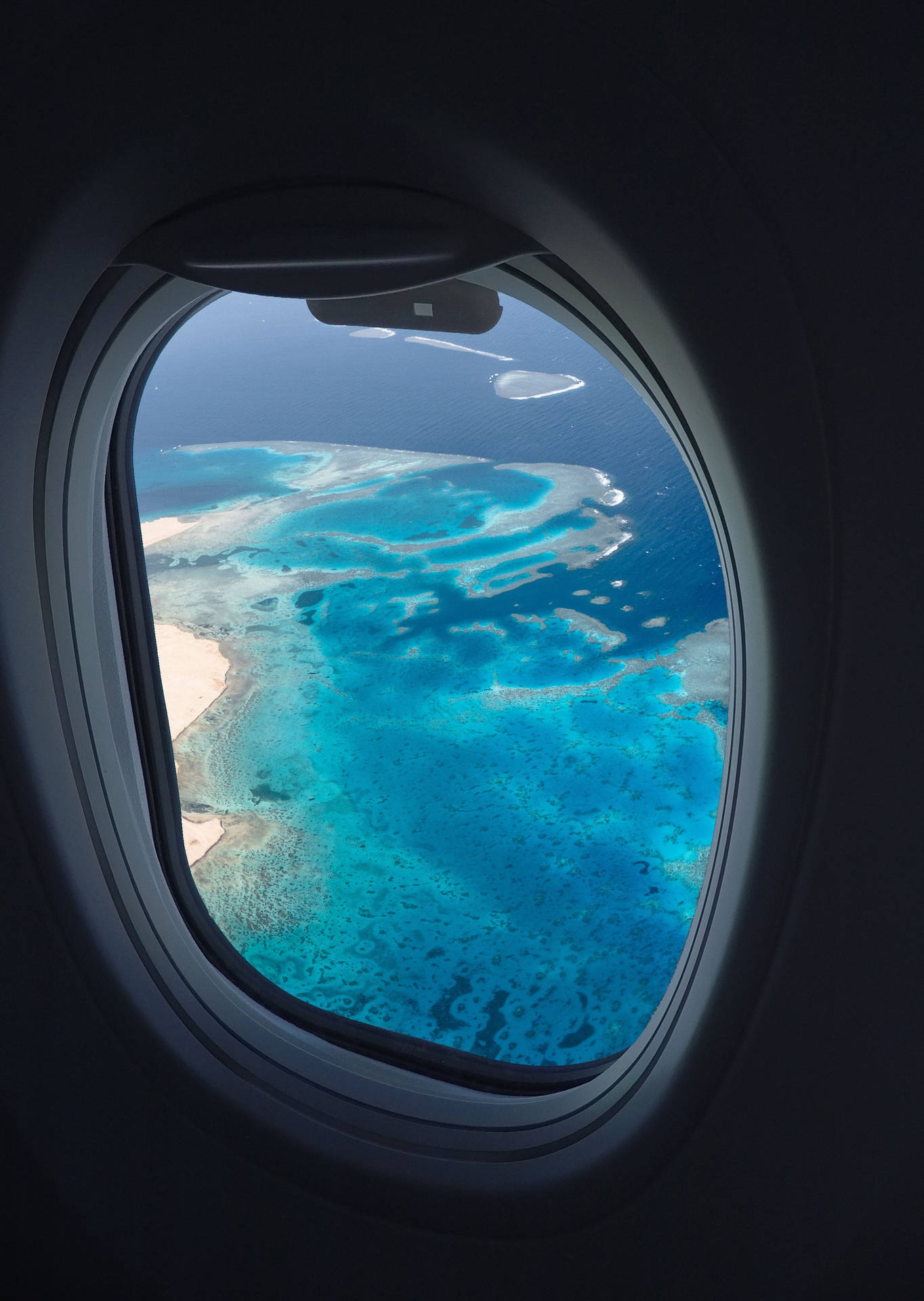 Clear Ocean Shot From A Plane Window Wallpaper