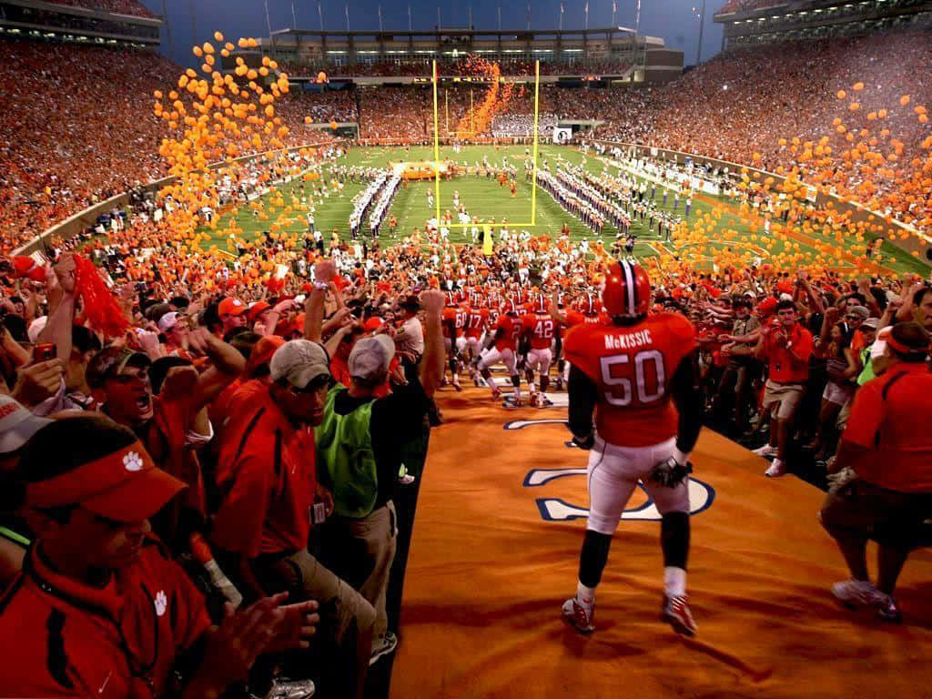 Clemson Tigers Football Team Entrance With Orange Balloons Wallpaper