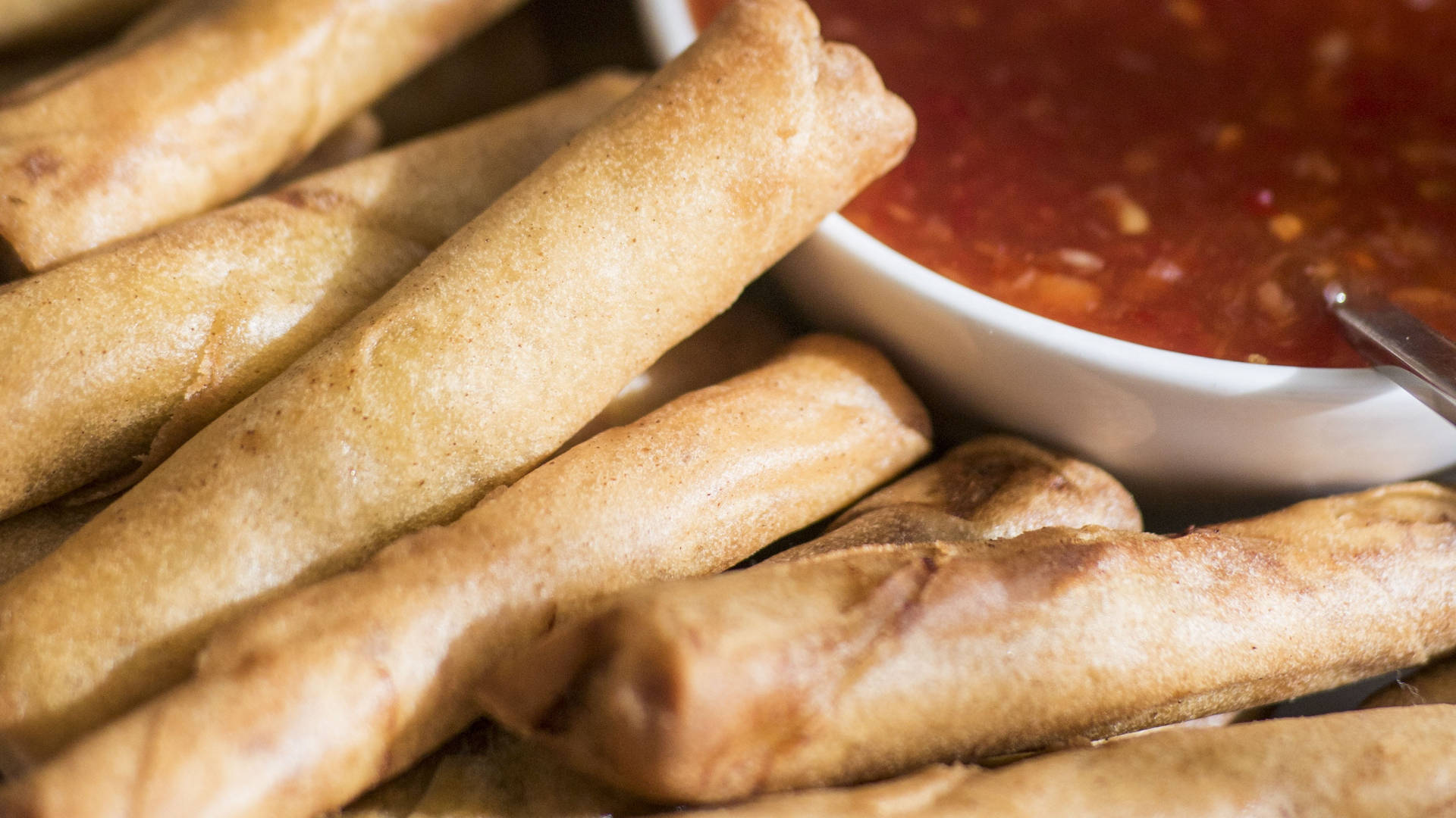 Close-up Of Egg Rolls With Dip