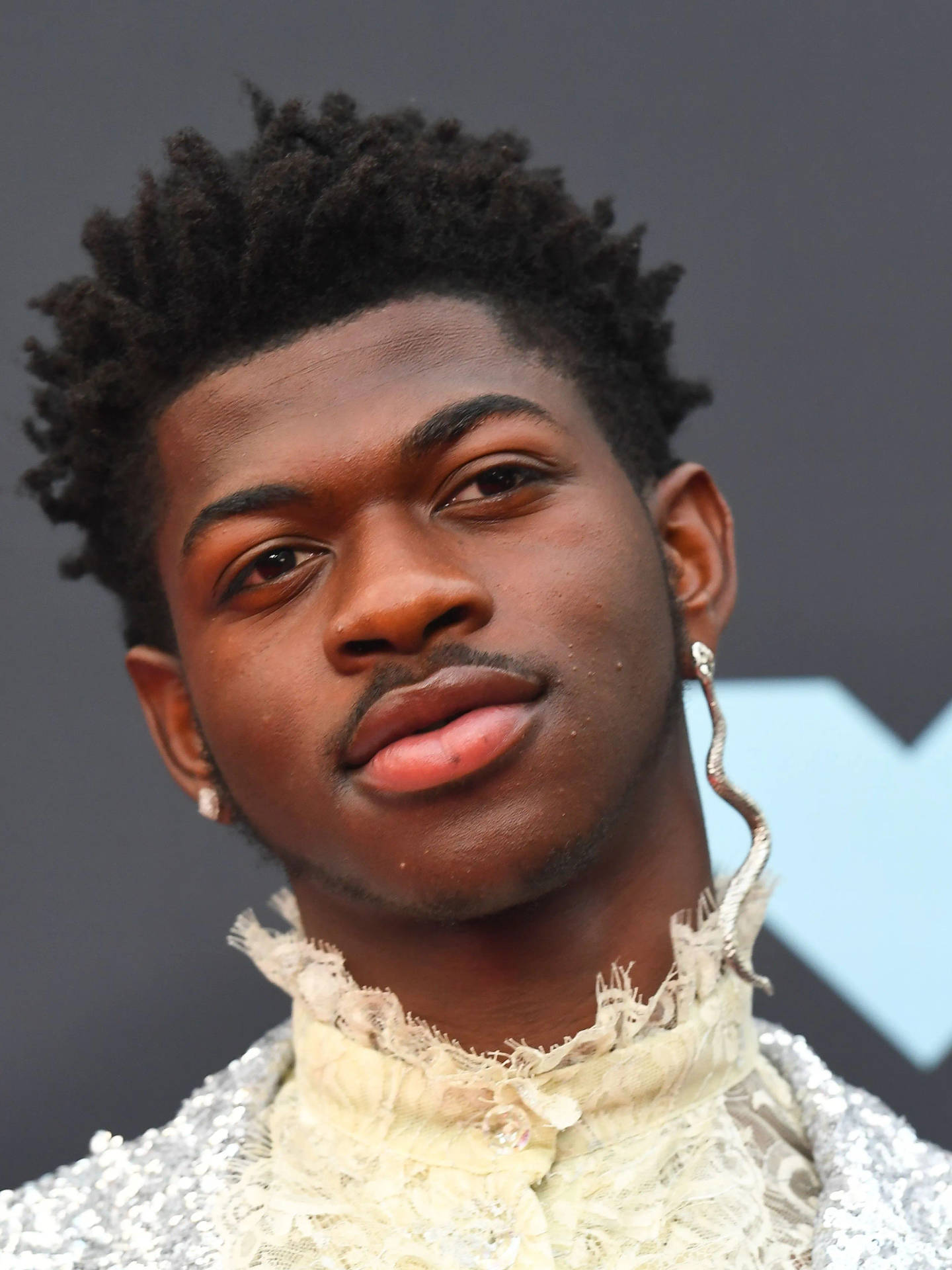 Close-up Photo Of Black Gay Man Lil Nas X Background