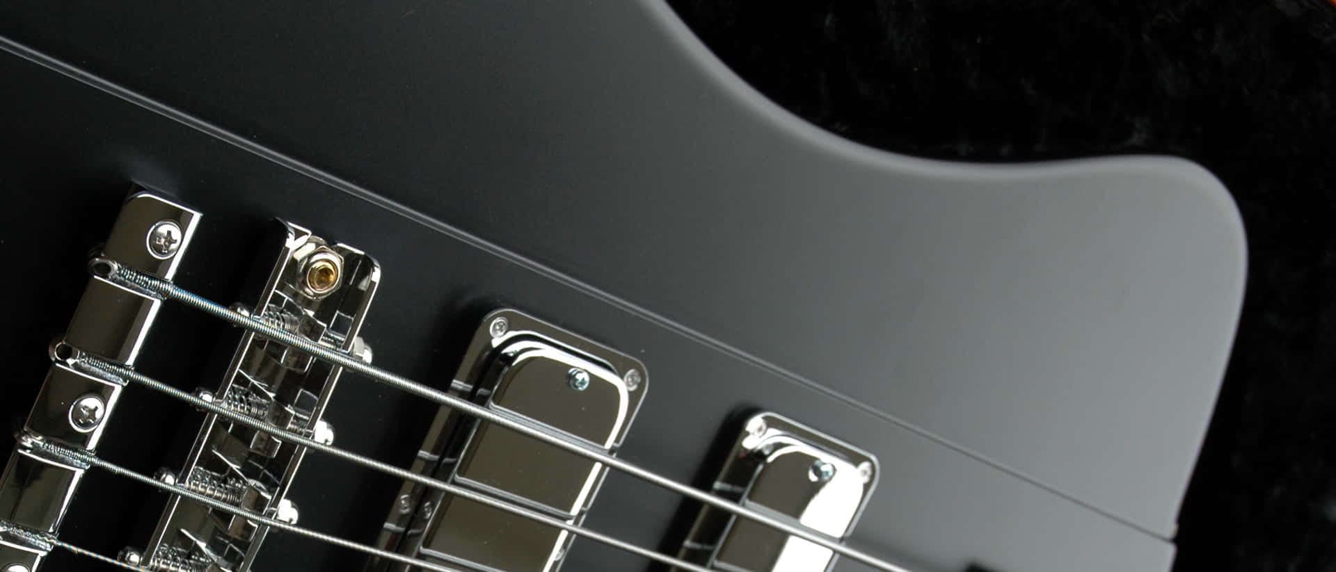 Closeup Bass Guitar Bridgeand Strings Wallpaper