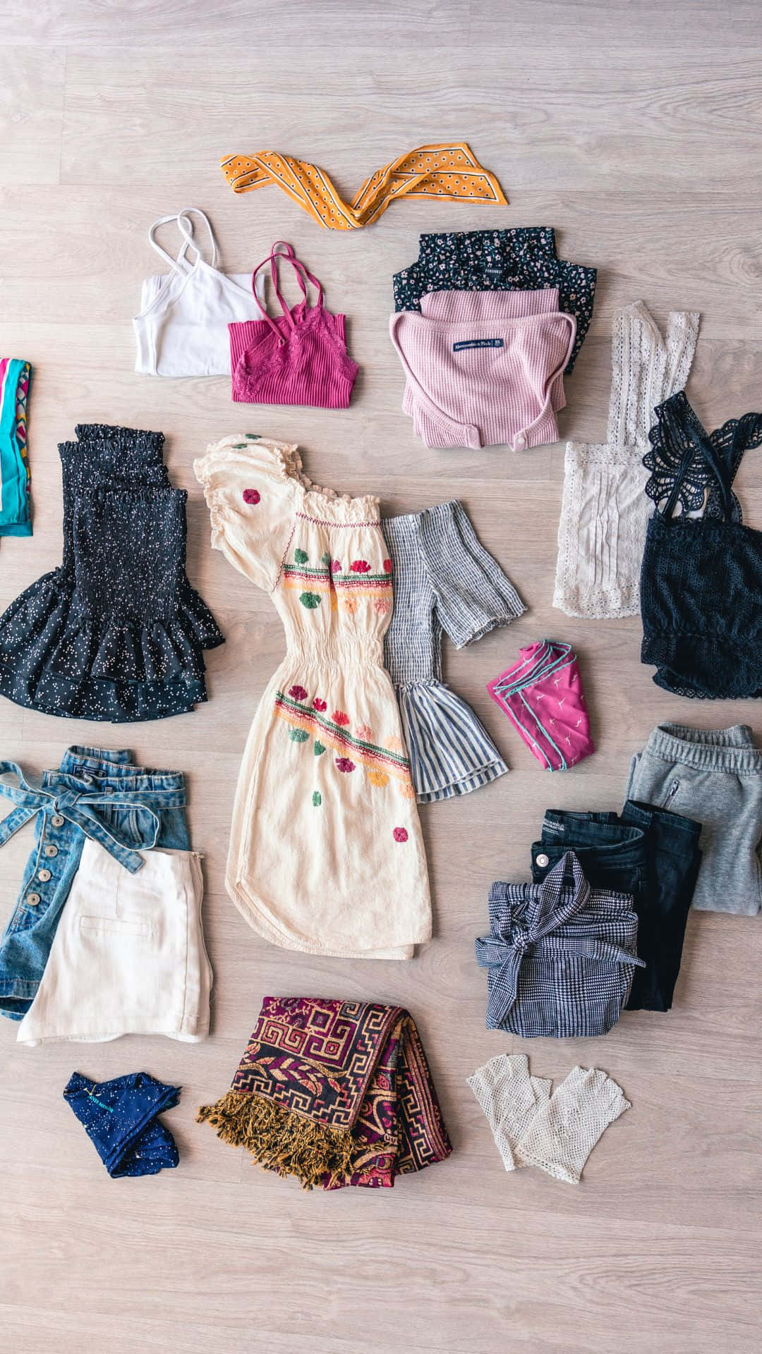 A Collection Of Clothes Laid Out On A Wooden Floor