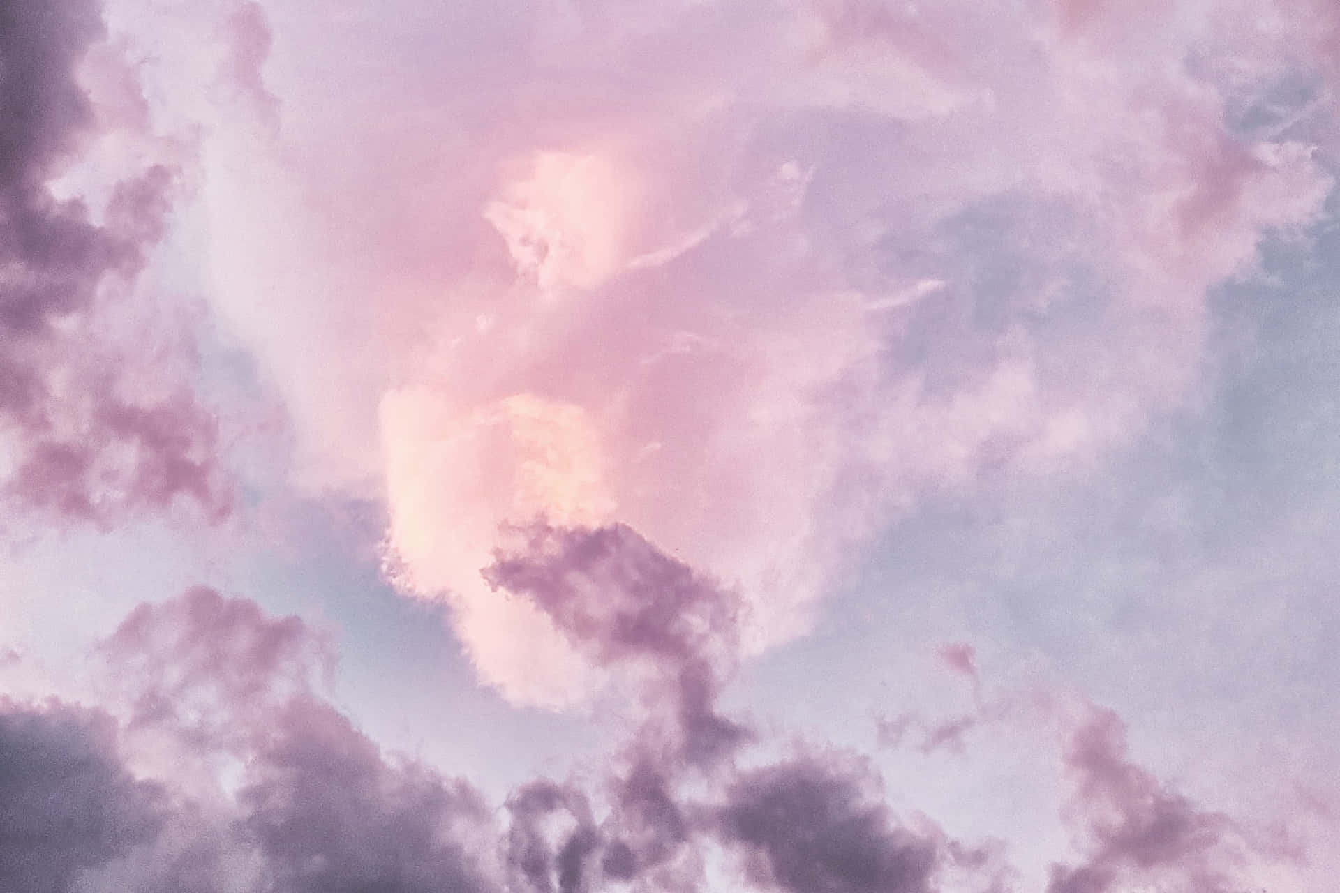 A Pink And Purple Sky With Clouds
