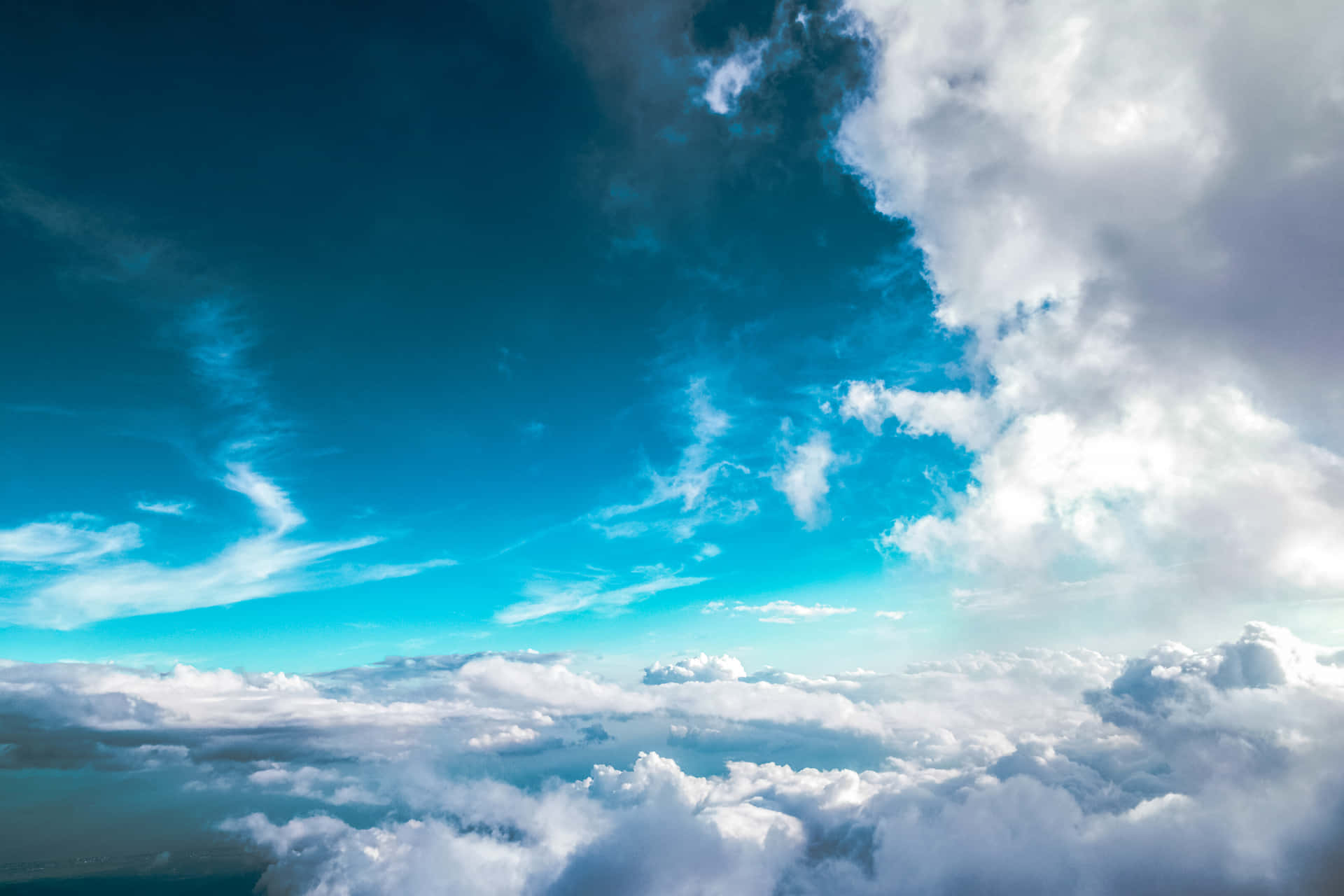 A Plane Flying Over The Clouds Wallpaper