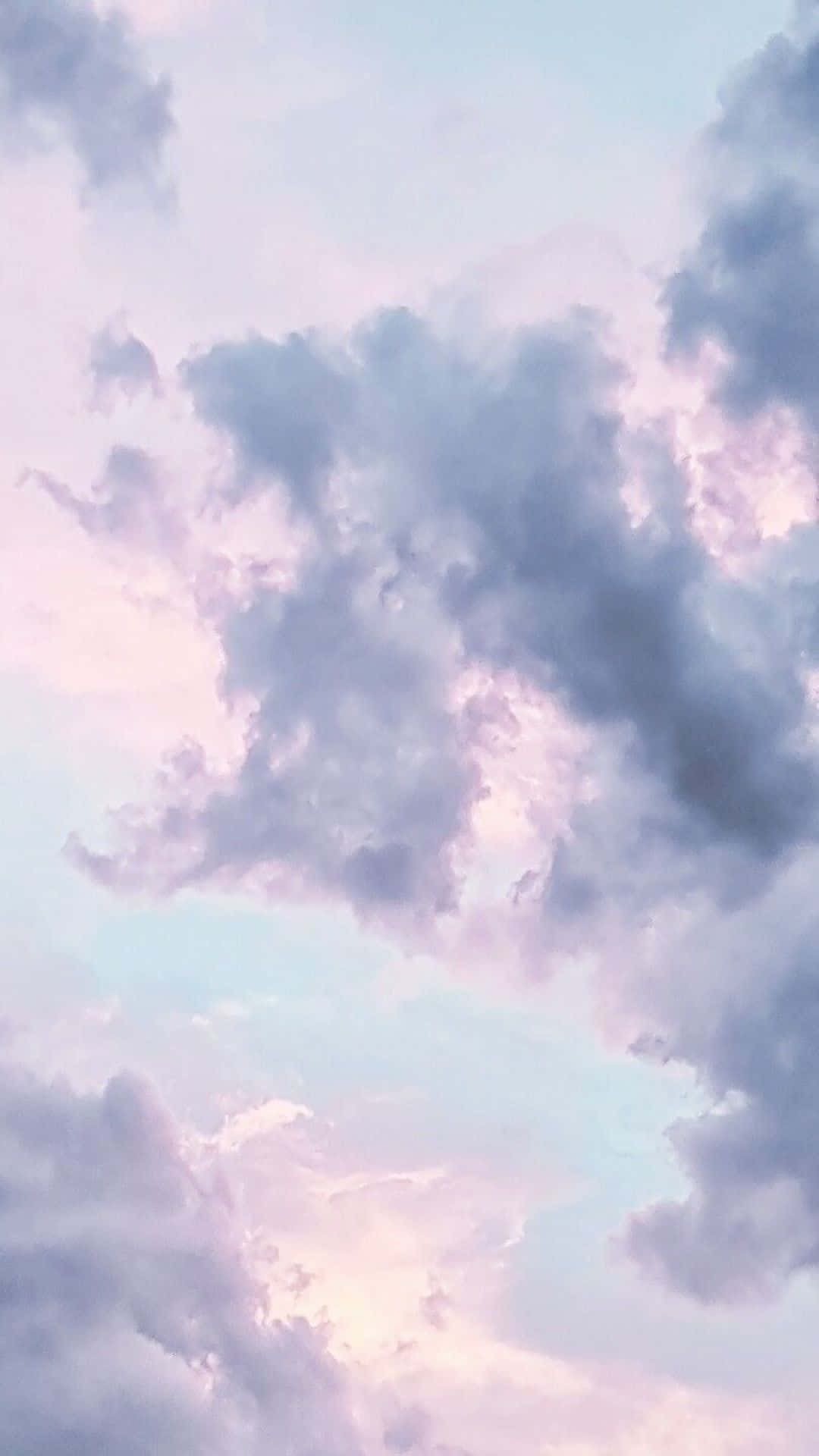 Dreamy clouds float above a brilliant sunset Wallpaper