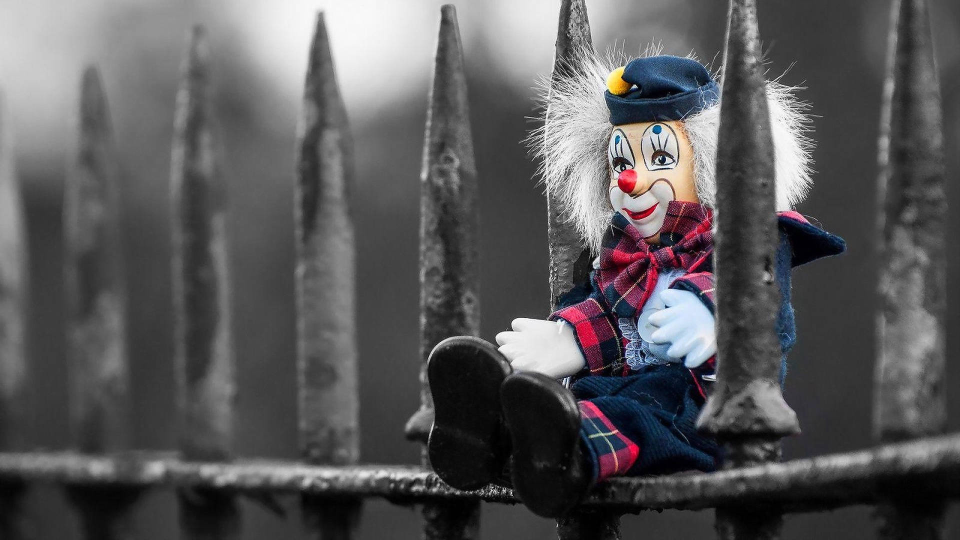 Clown Doll On Fence Wallpaper