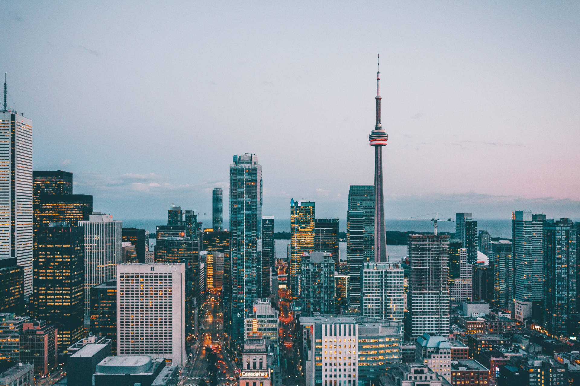 Caption: Majestic View of CN Tower Dominating the Toronto Skyline Wallpaper