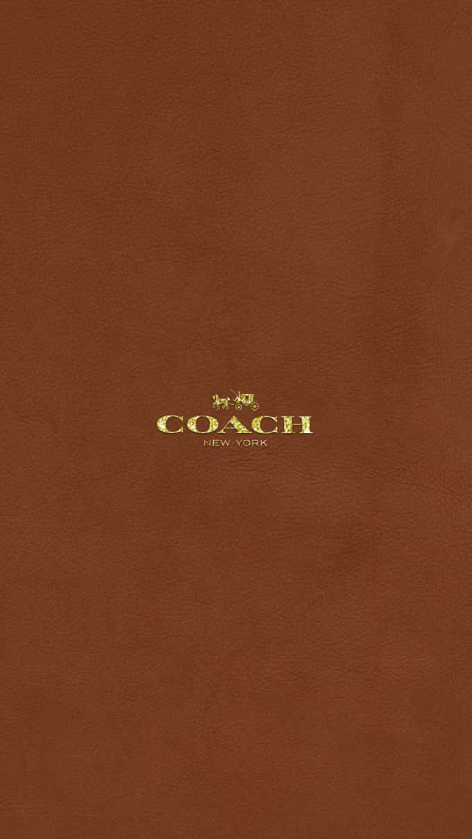 Coach Logo On A Brown Background Wallpaper