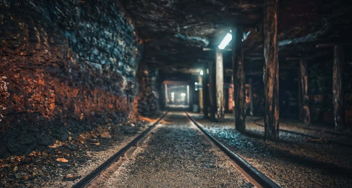 A Train Track In A Dark Tunnel