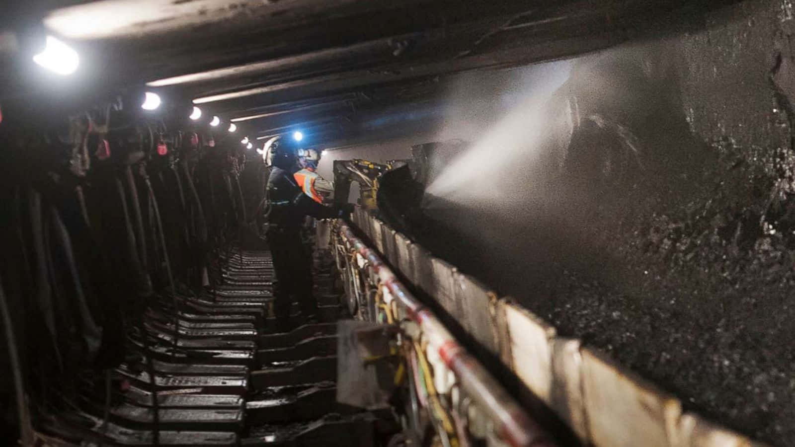 A Worker Spraying Water On A Train Track