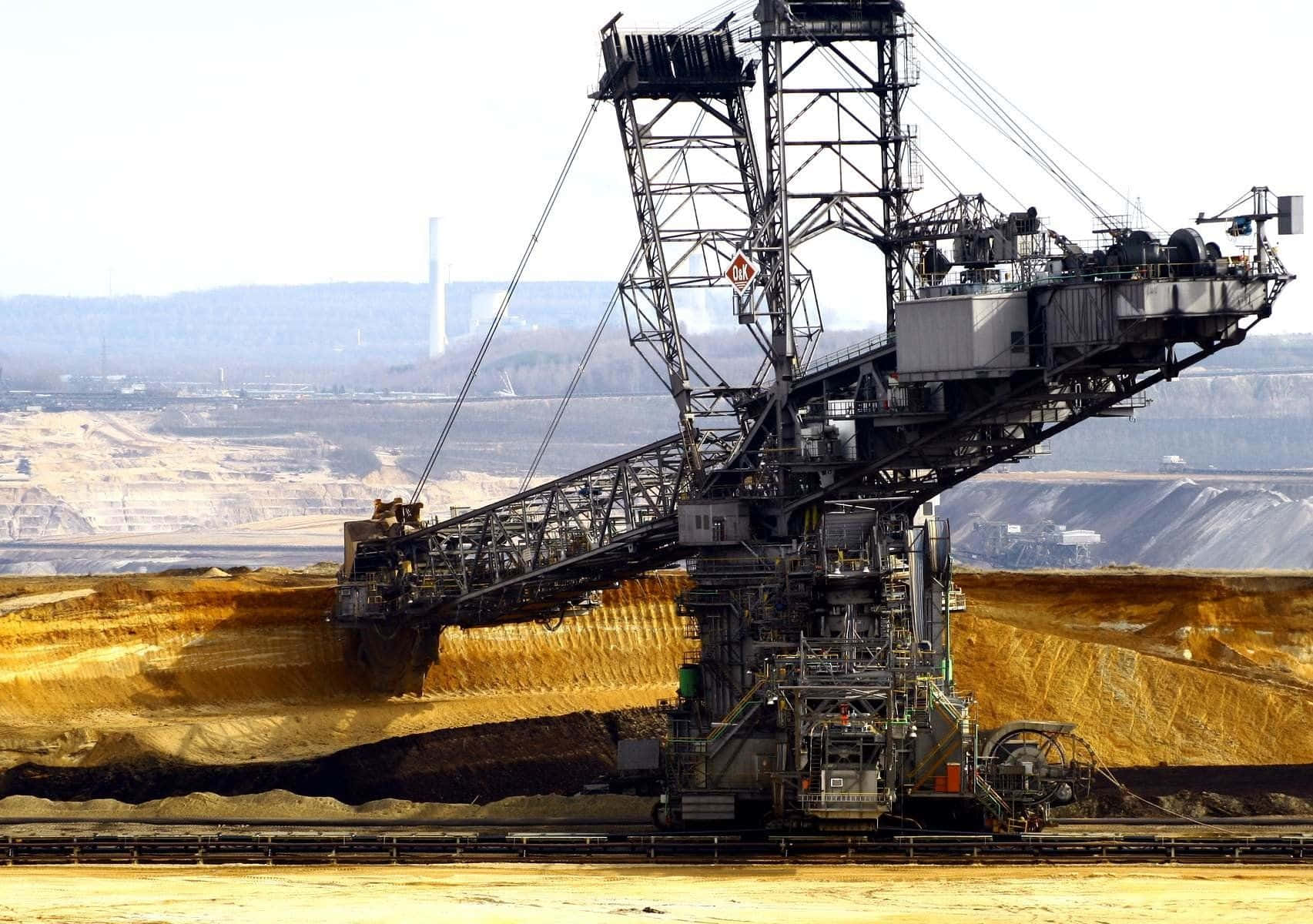 A Large Crane Is Working In A Large Pit