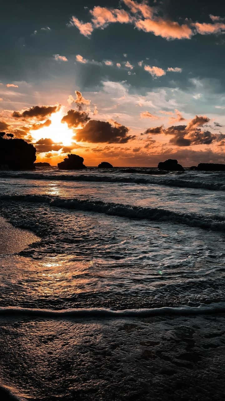 Coastal Sunset - A Serene Beach View Wallpaper