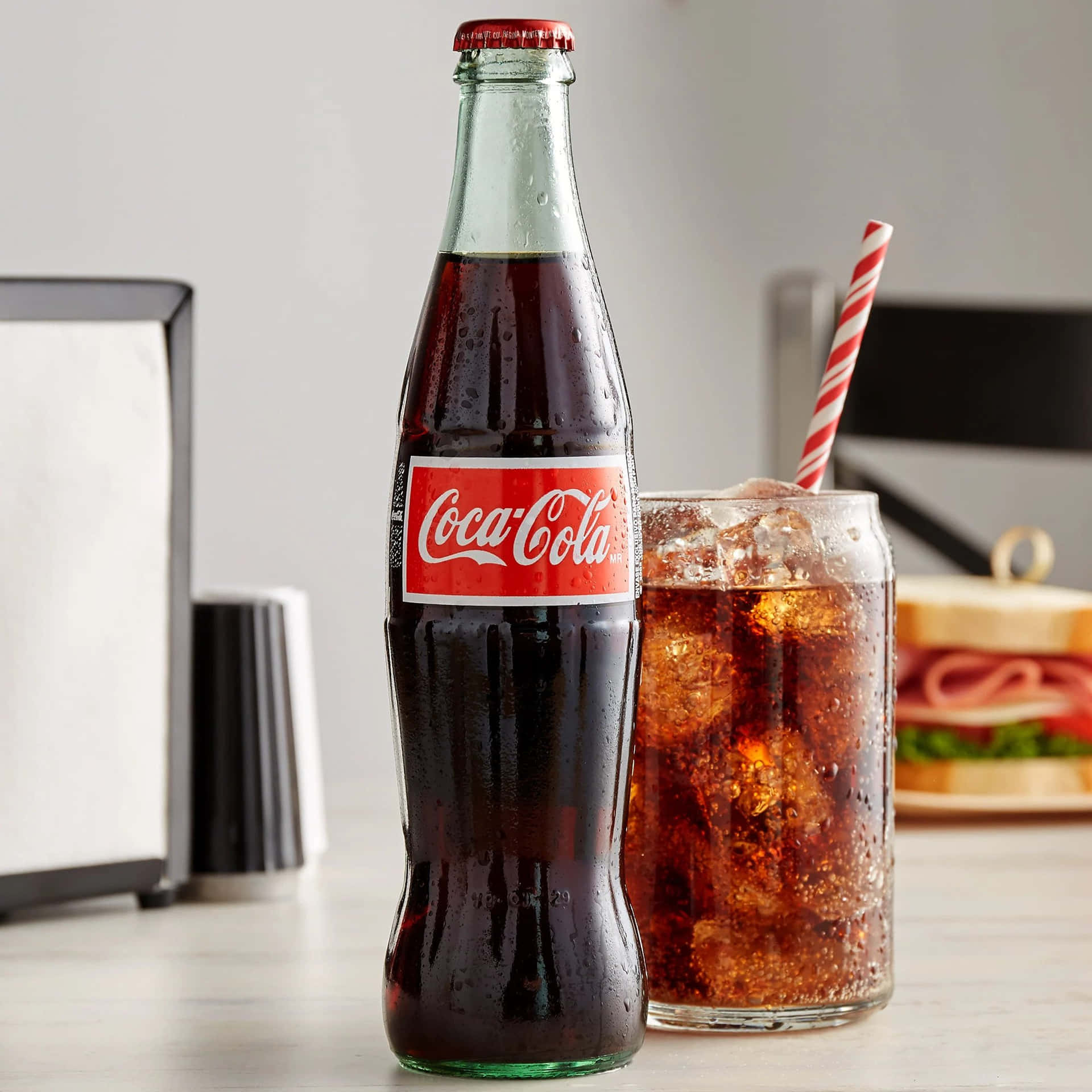A Classic Refreshment Moment: Enjoying a Chilled Bottle of Coca Cola