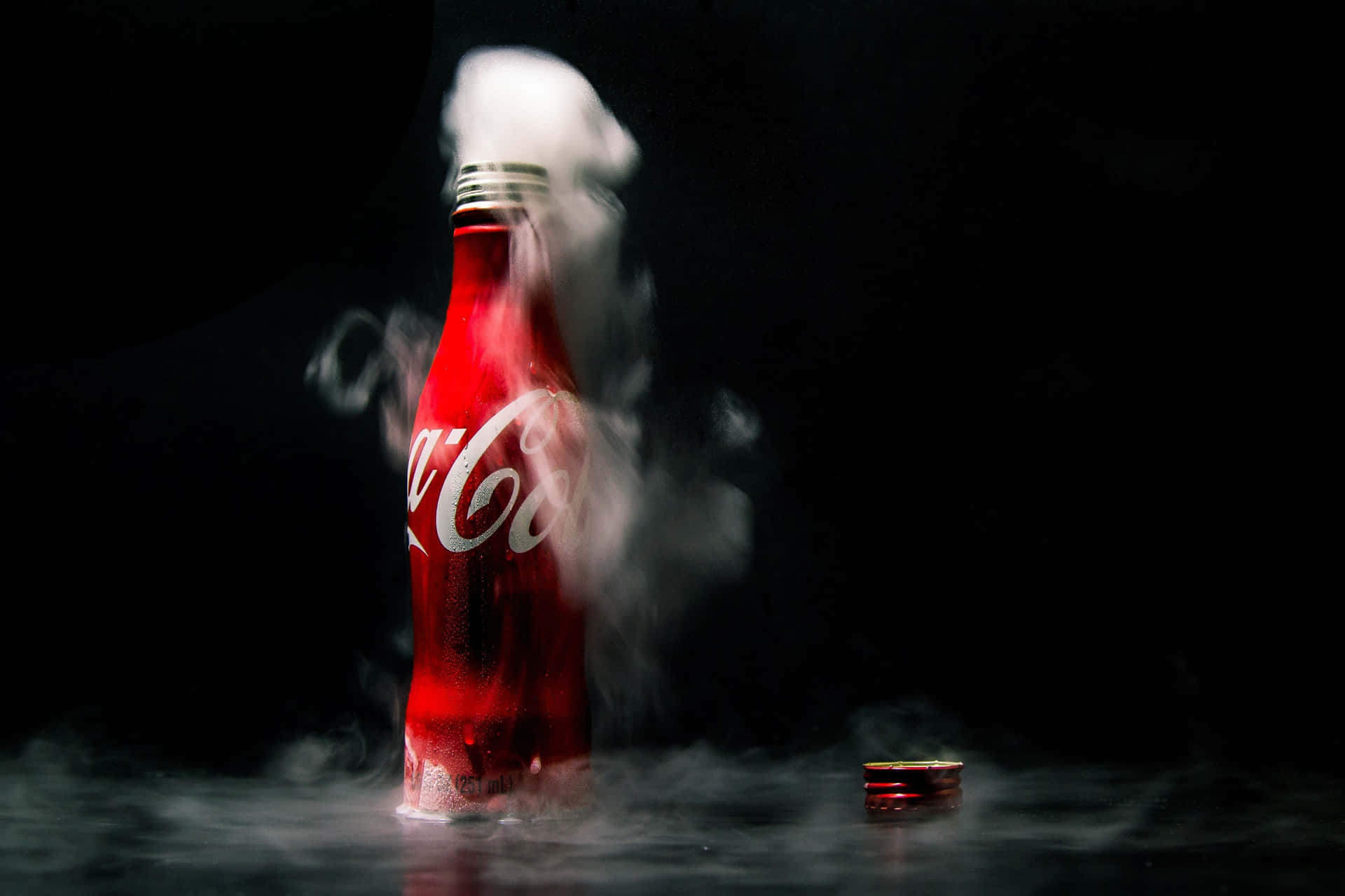 Refreshing Bottle of Coca-Cola Against a Red Background