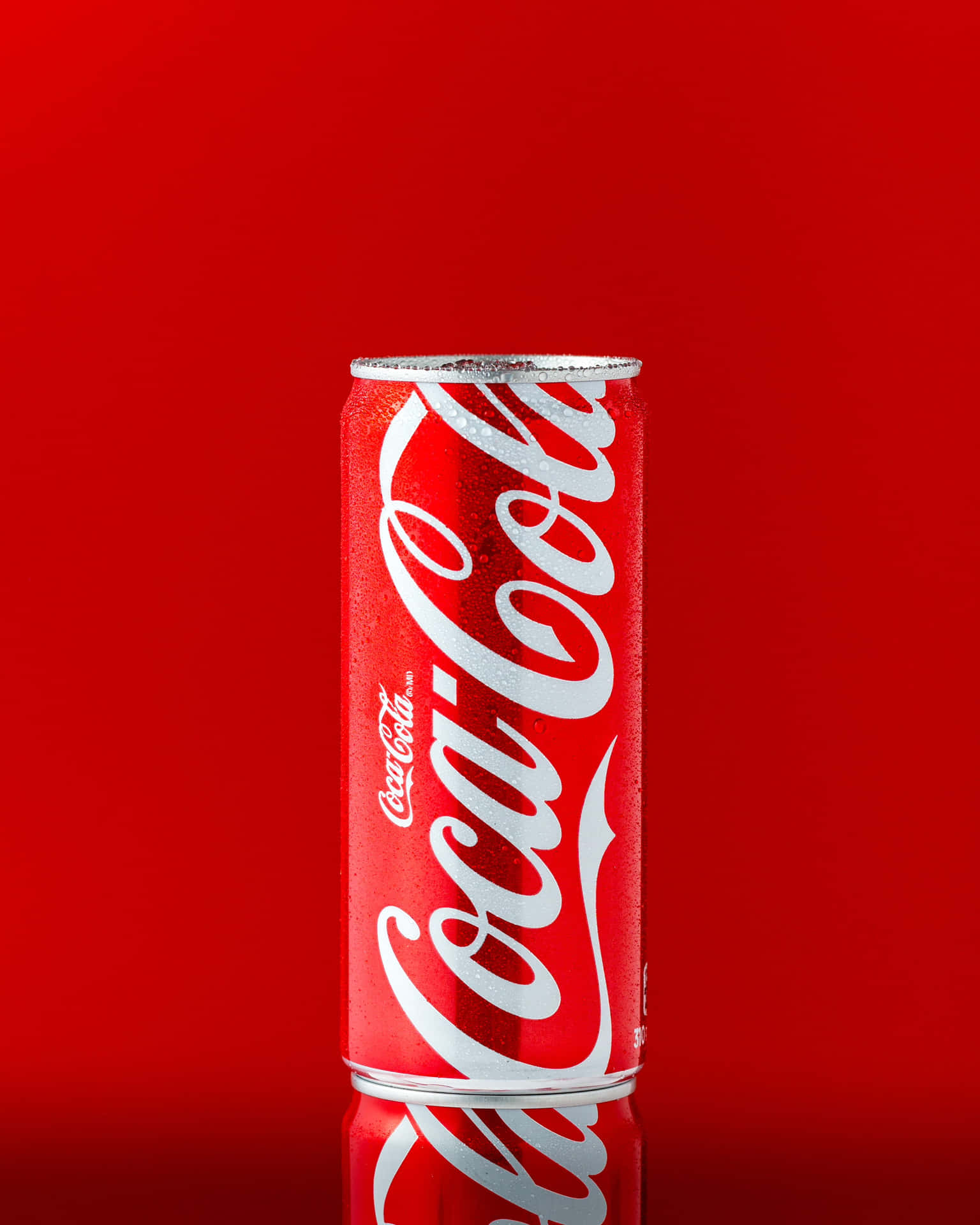 A Can Of Coca Cola On A Red Background