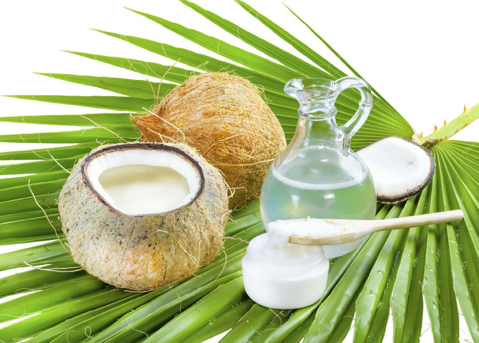 Coconut Oil And Coconut Leaves On A White Background