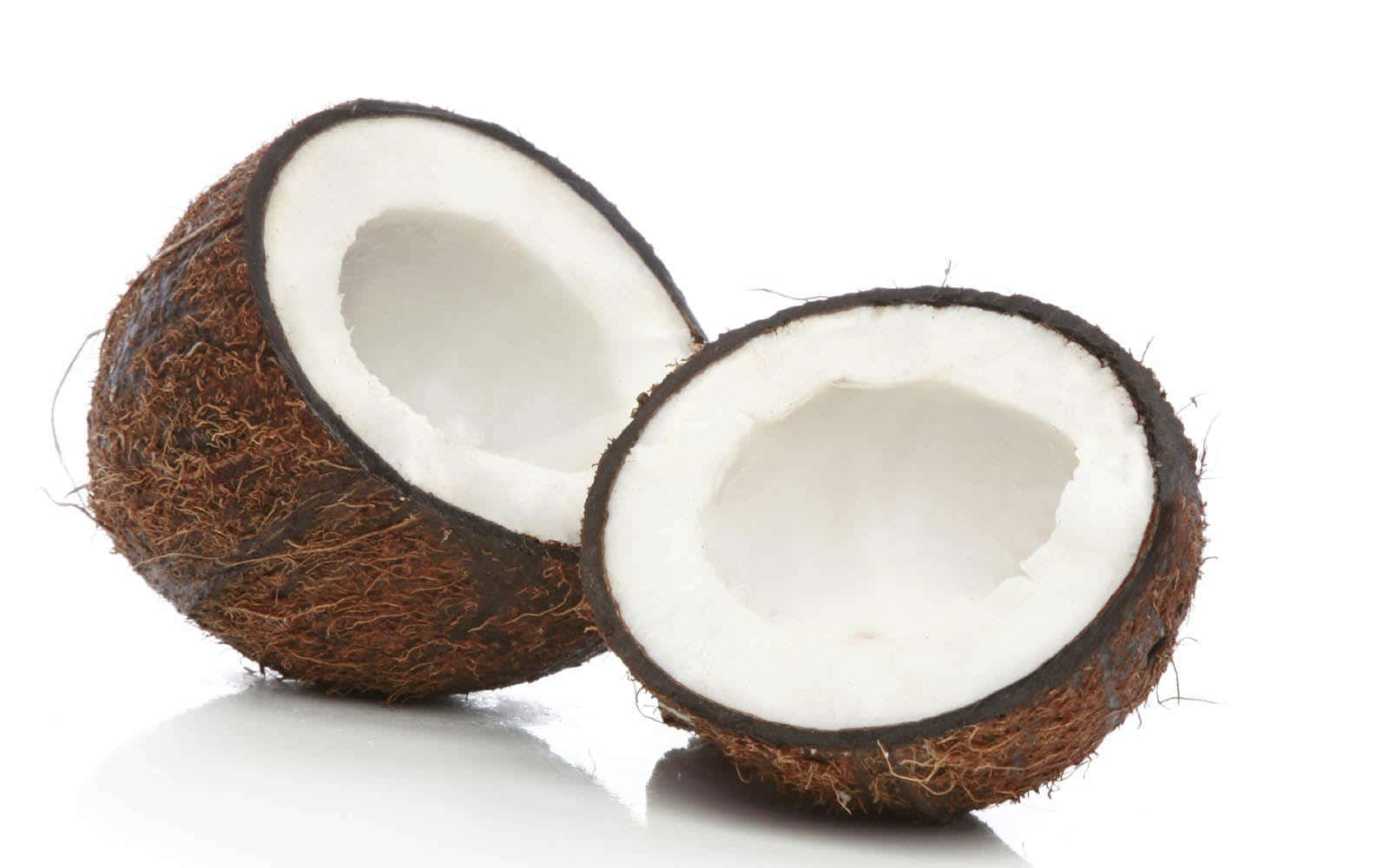 Two Coconuts Are Cut In Half On A White Background