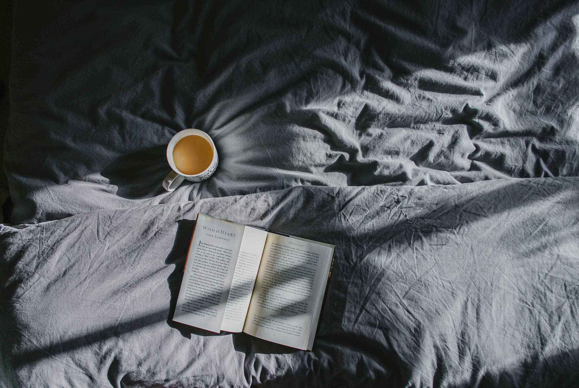 Coffee and book on bed wallpaper