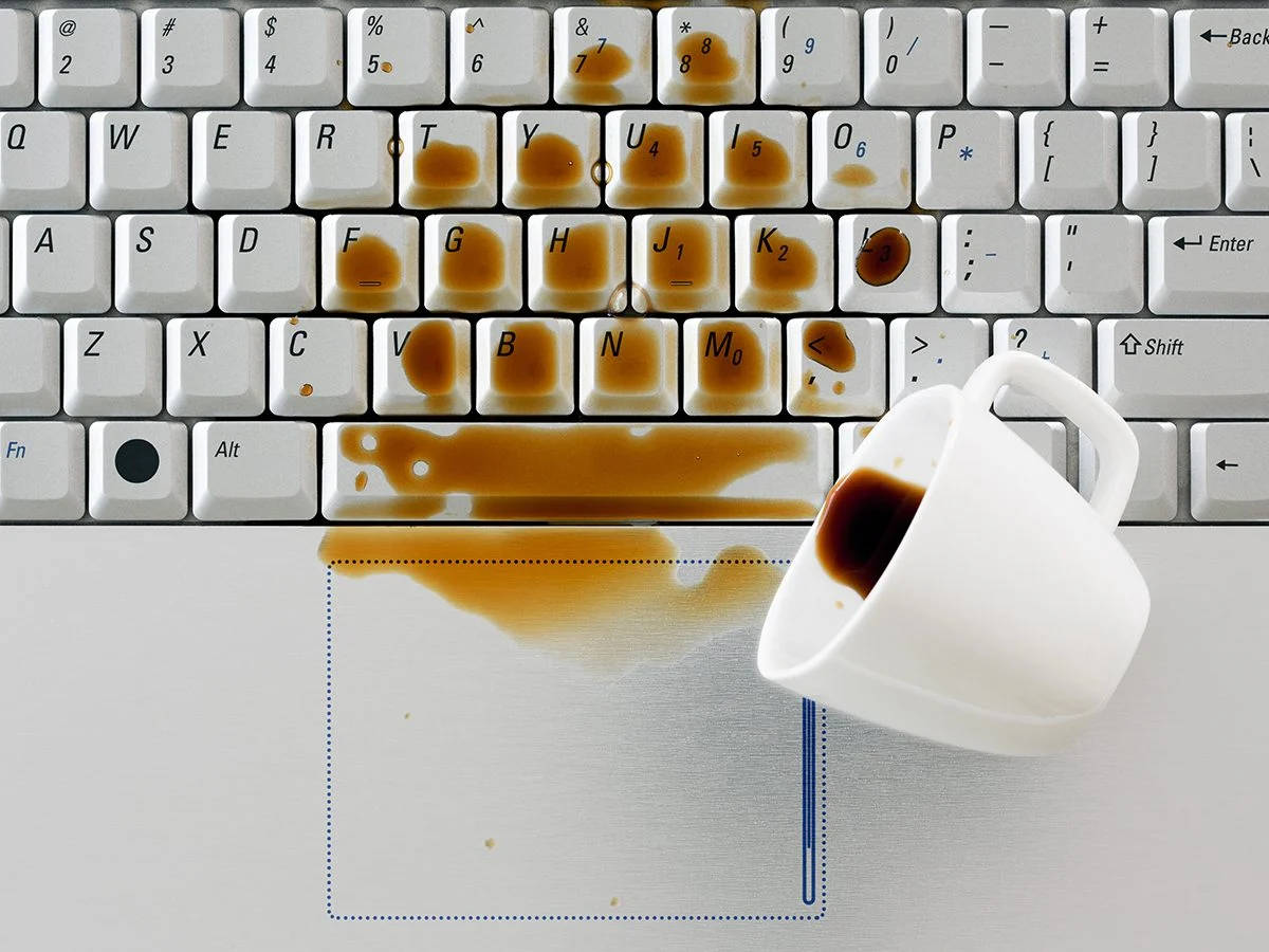 Coffee Spilled On Laptop Background