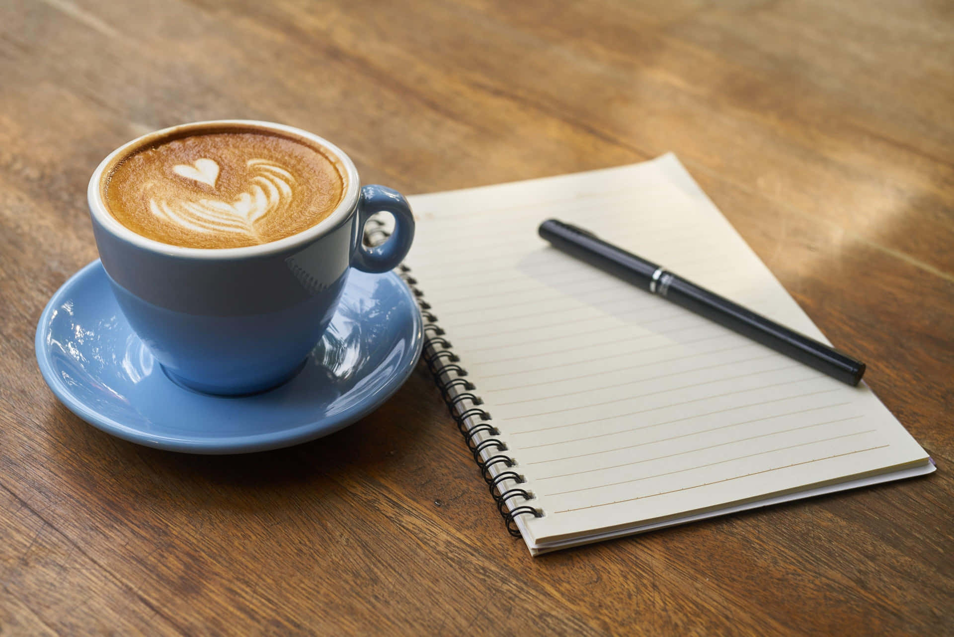 Coffeeand Notebookon Table Wallpaper