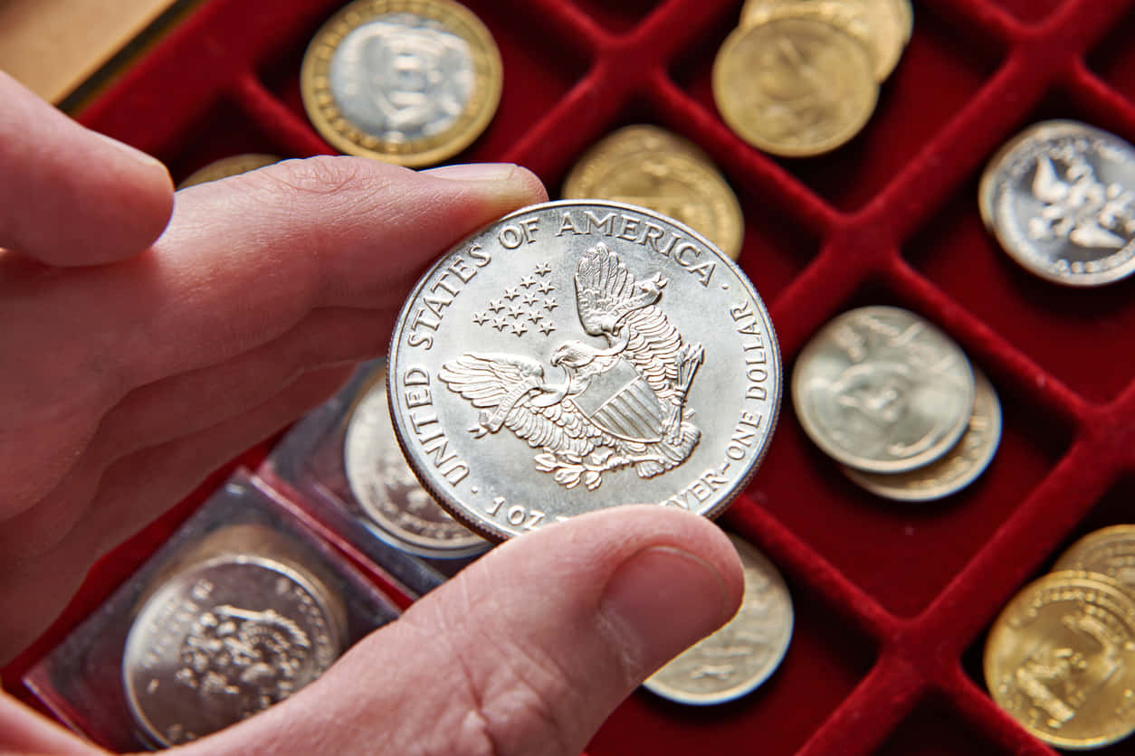 A Person Holding A Coin In A Red Case