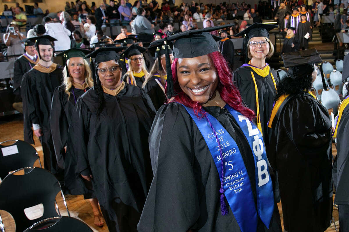 A Group Of Graduates In Graduation Gowns