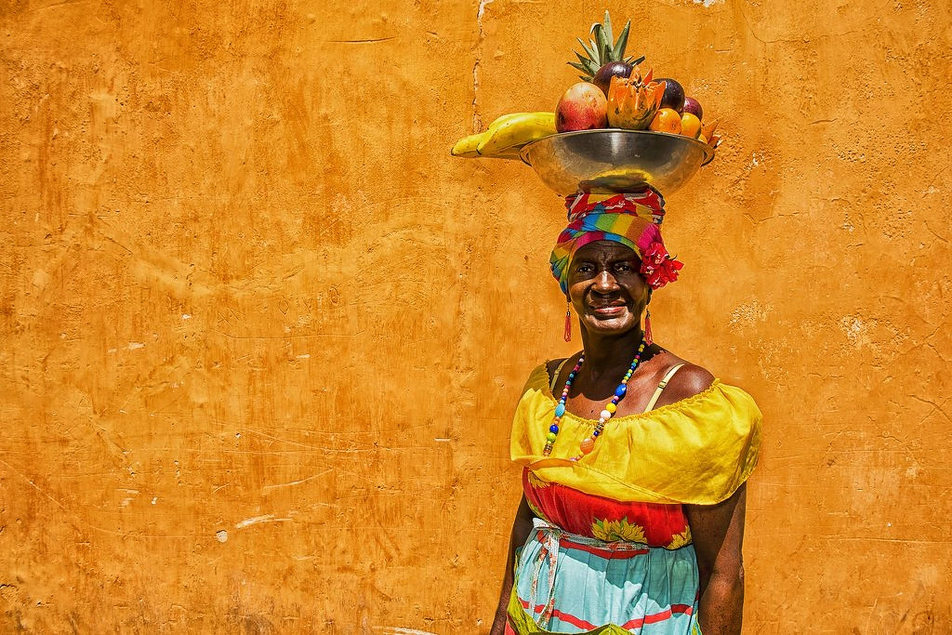 Palenquera Lady Carrying Fruit Basket in Colombia Wallpaper