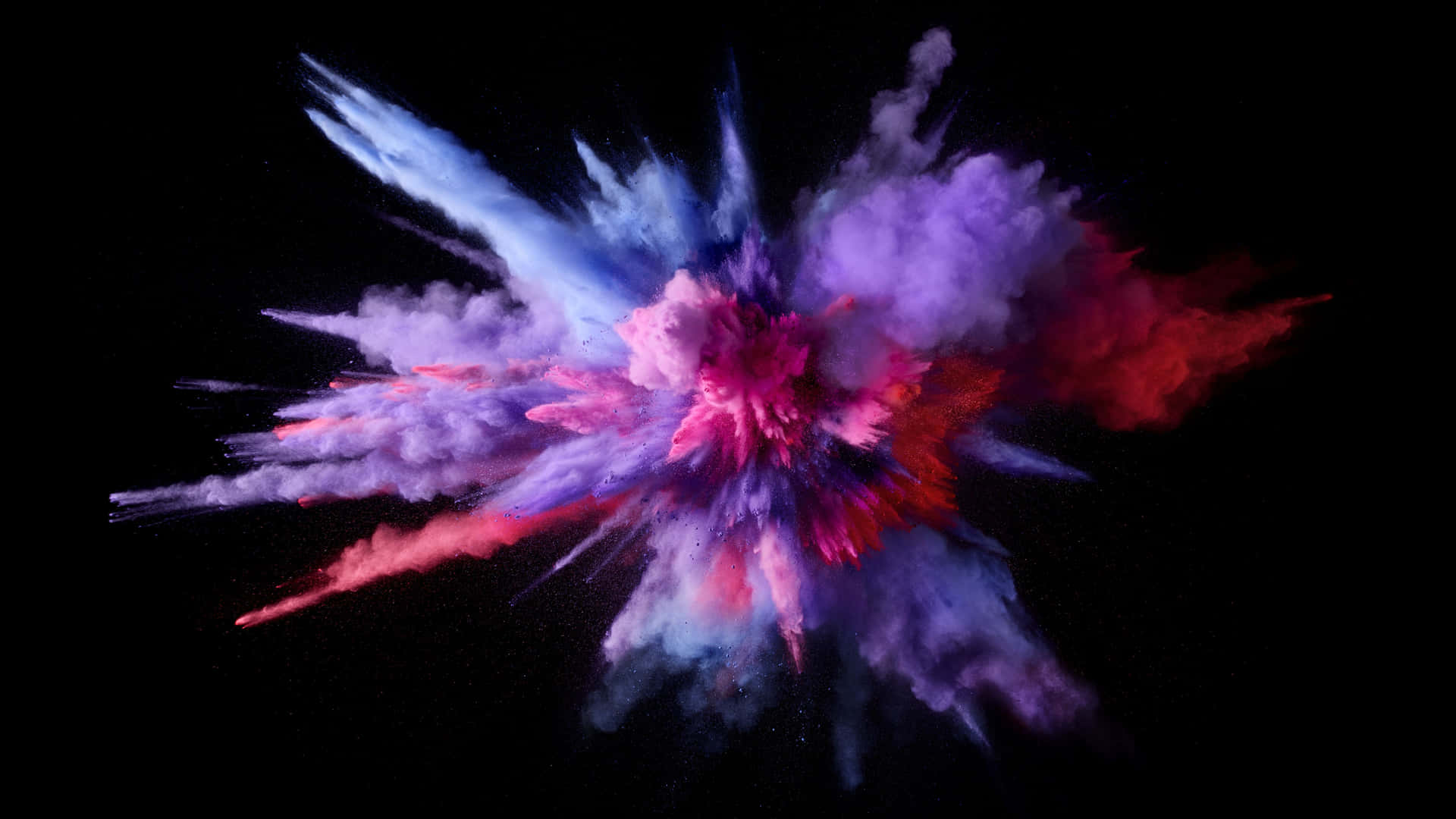 A Colorful Powder Explosion On A Black Background