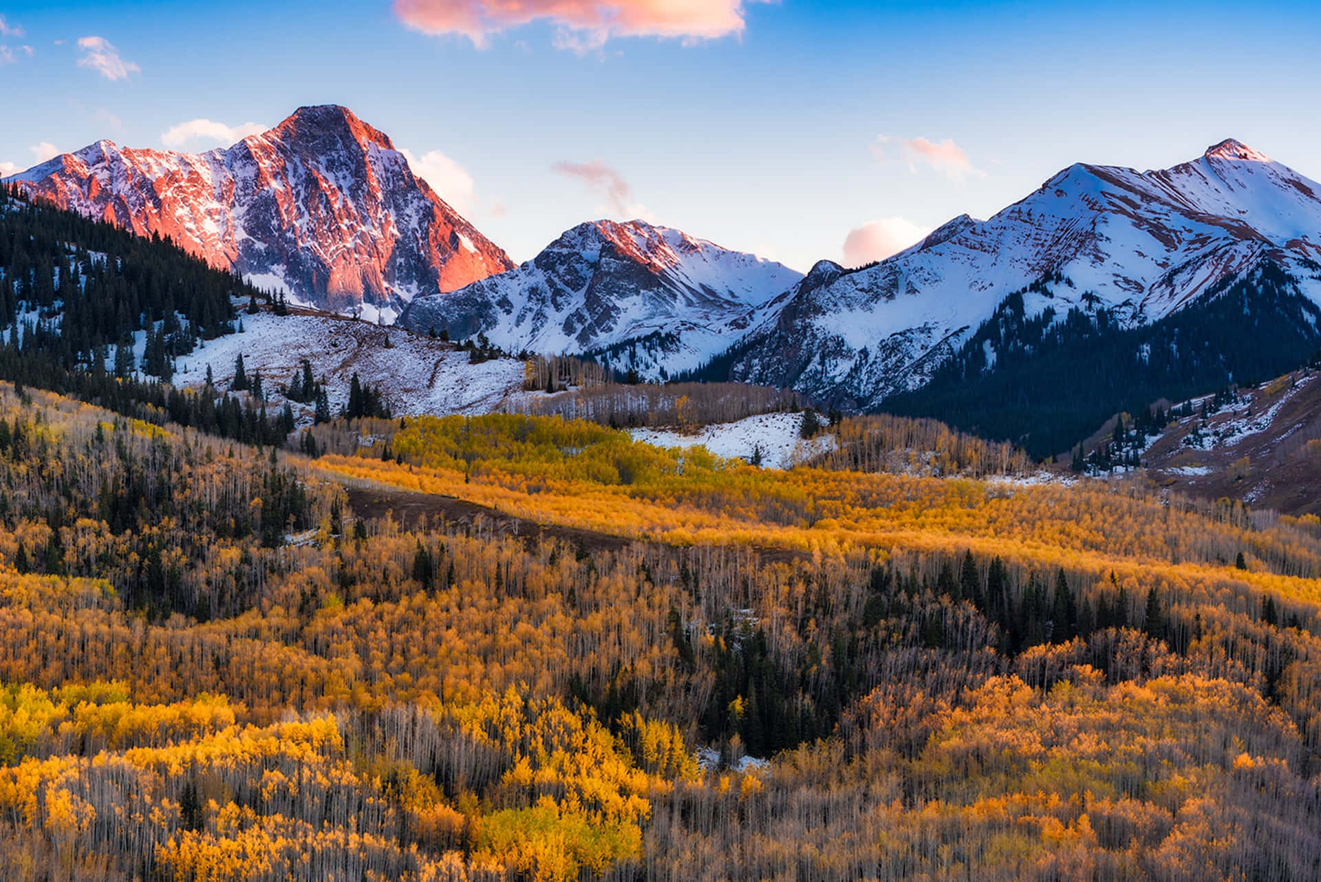 A Mountain Range With Trees And Mountains In The Fall