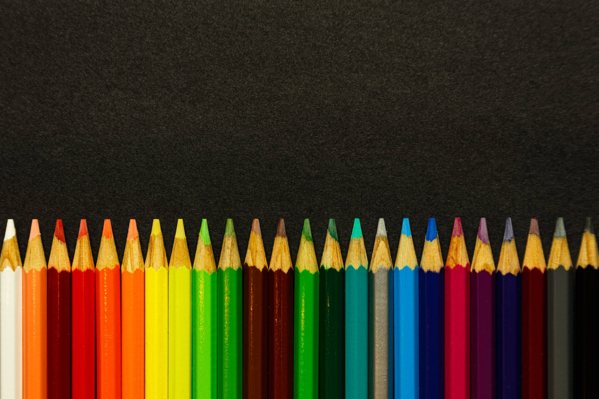Colored Sharp Pencils Against Black Surface Wallpaper