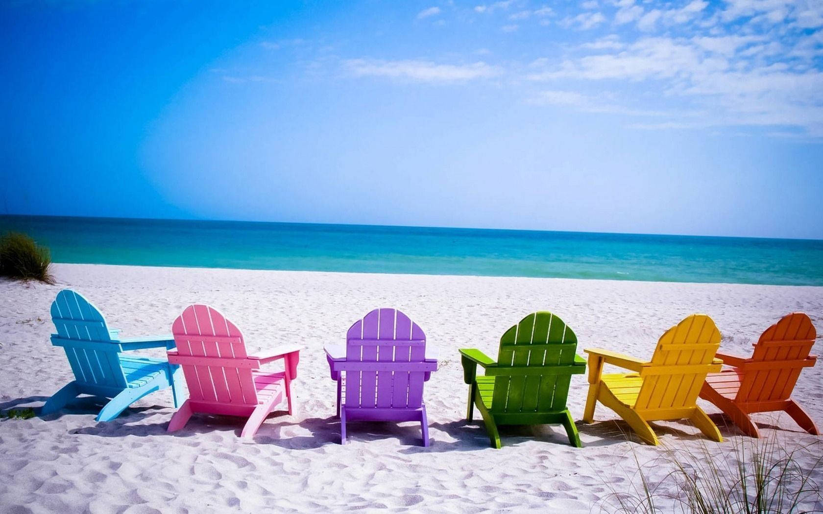 Enjoy the breathtaking view from colorful beach chairs Wallpaper