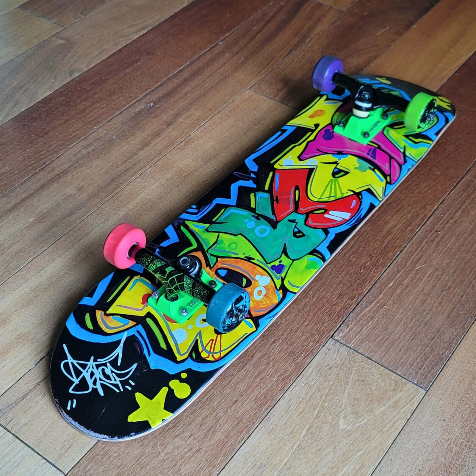Colorful Graffiti Skateboardon Wood Floor Wallpaper