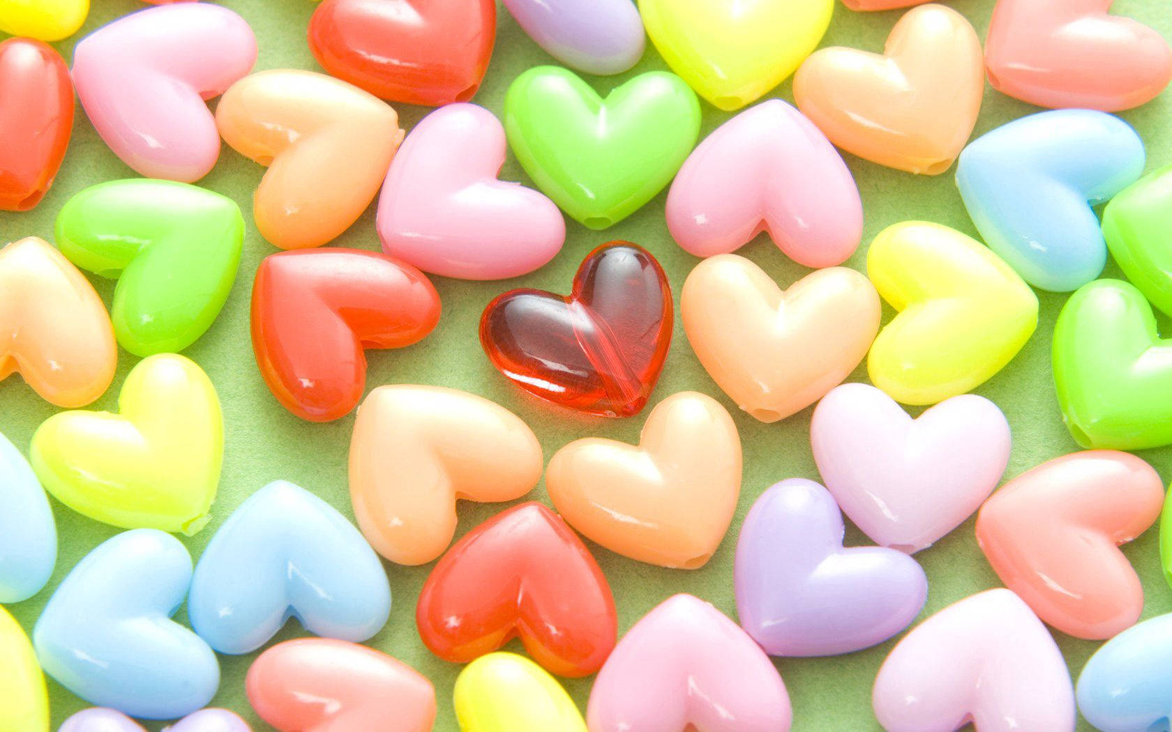 Colorful Hearts On Green Table Wallpaper