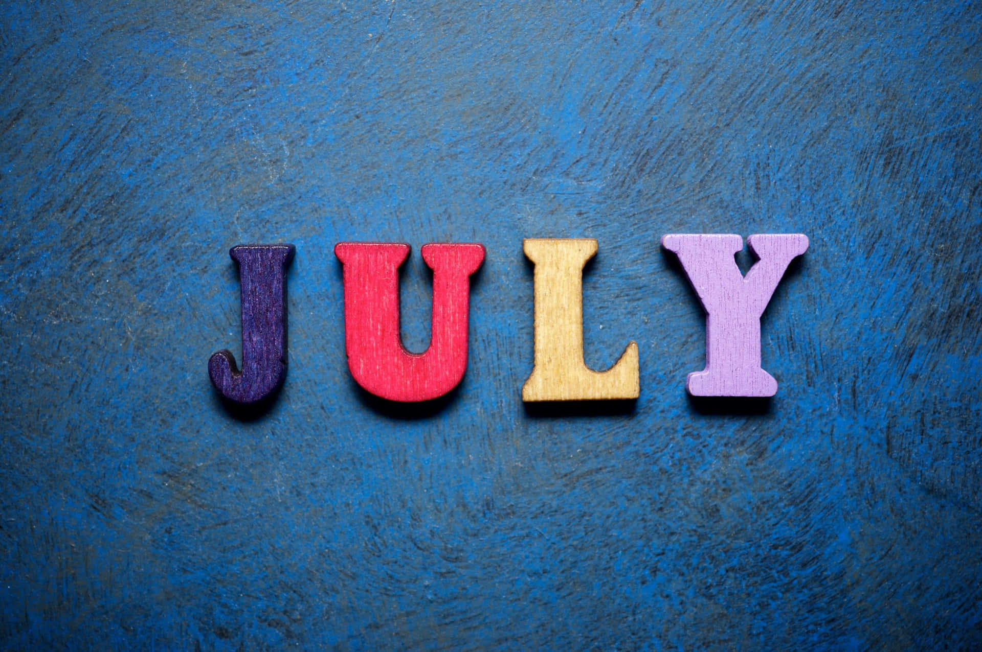 Colorful July Letterson Blue Background Wallpaper