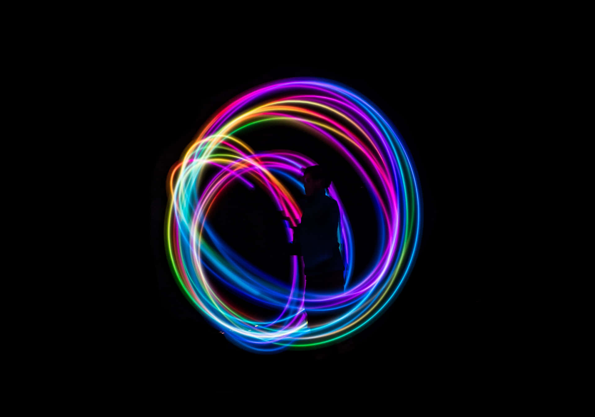 A Colorful Light Ring On A Black Background Wallpaper