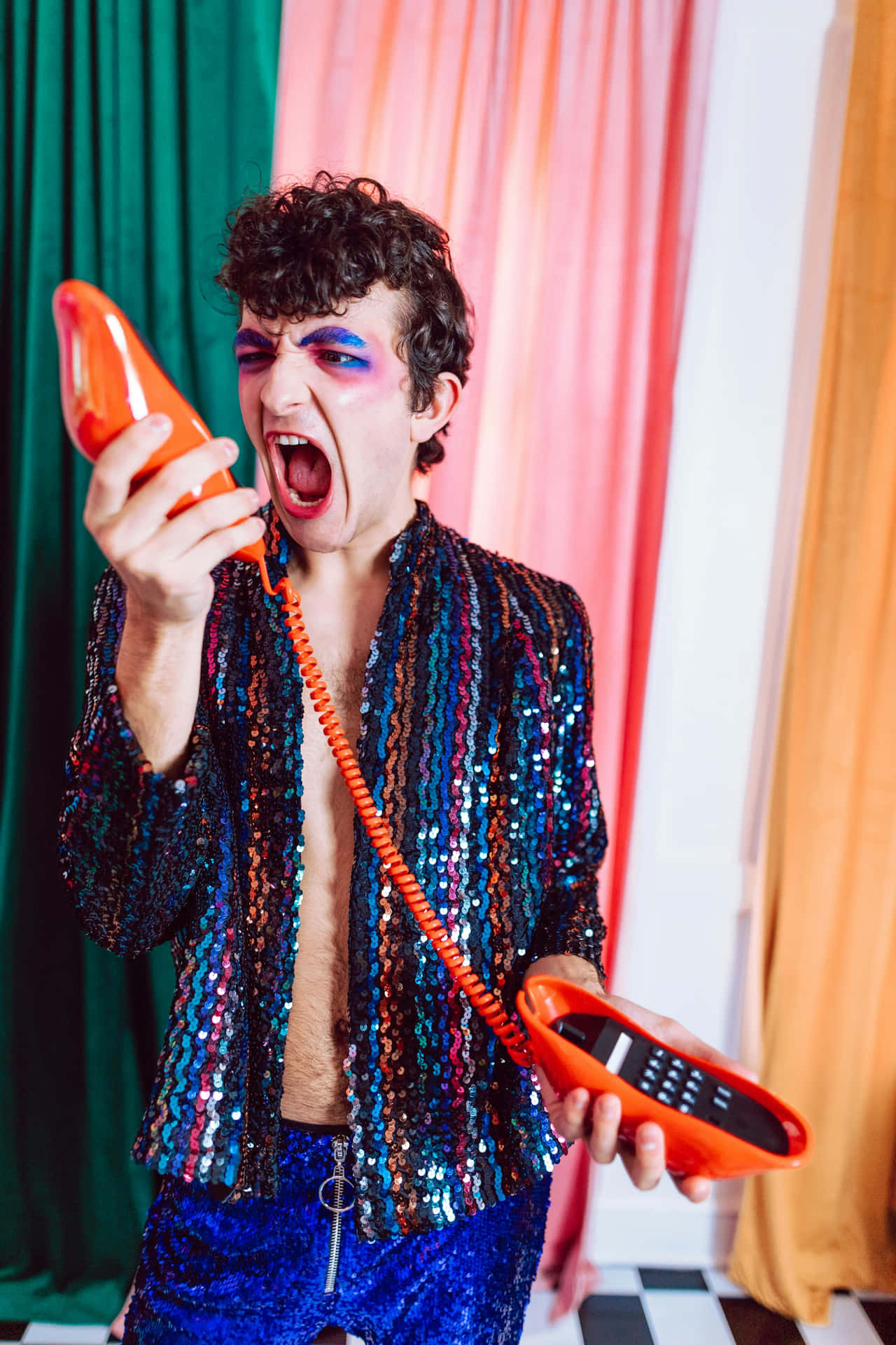 Colorful Outfit Man Yelling Into Phone Wallpaper