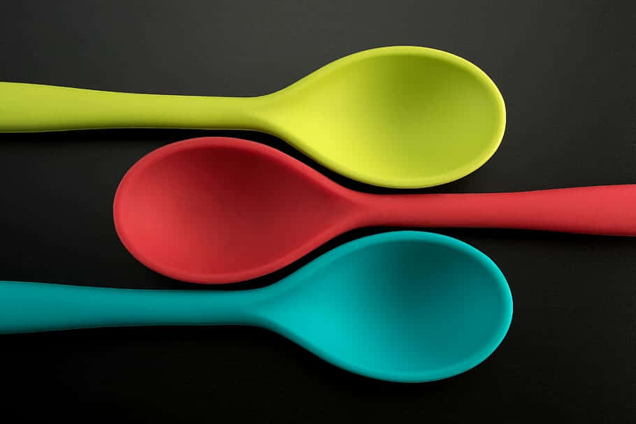 Colorful Plastic Spoons Black Background Wallpaper