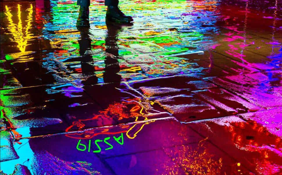 Colorful Rainy Pavement Reflections Wallpaper