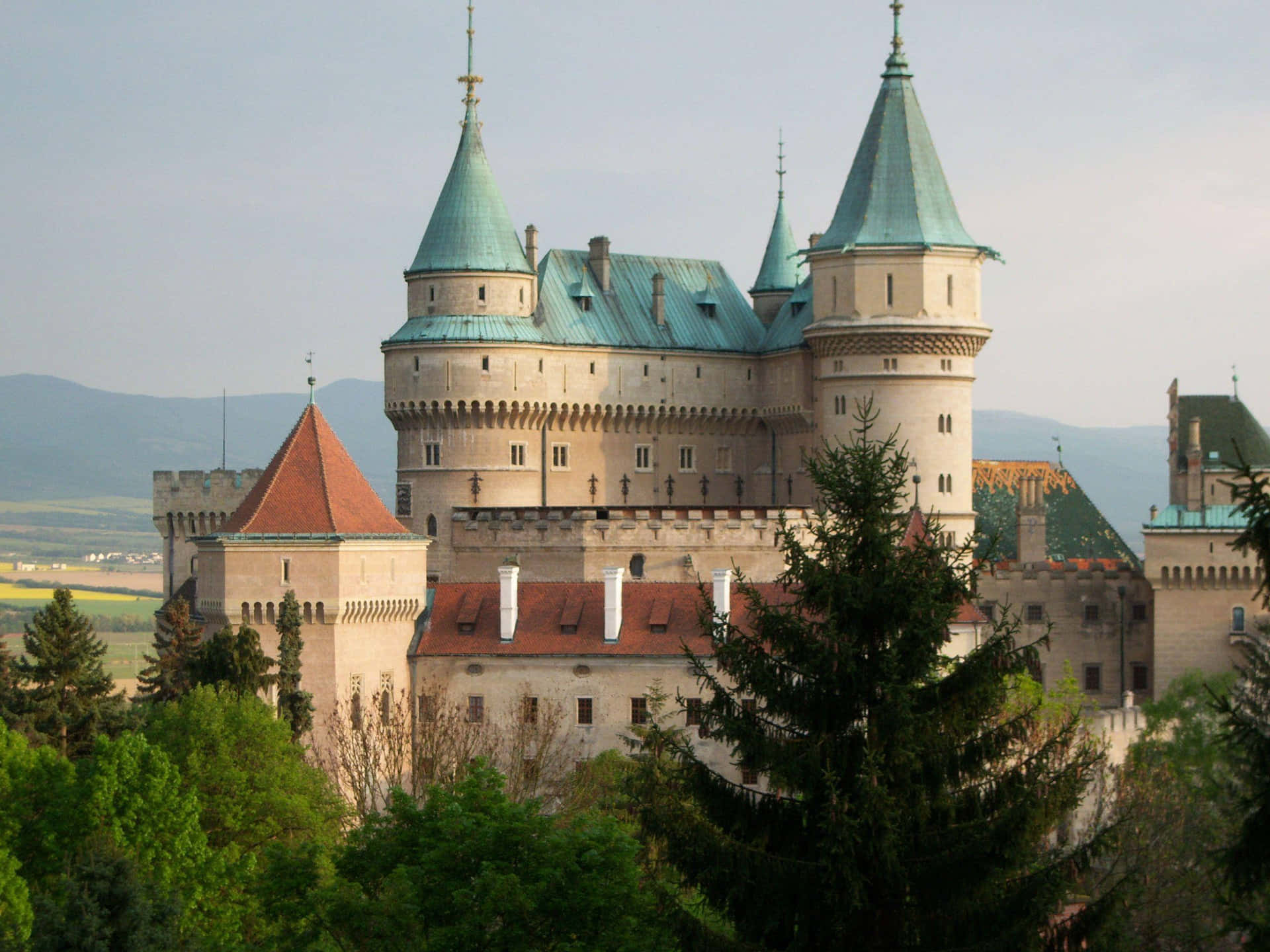 Breathtaking View of the Vibrant Rooftops of the Enchanting Bojnice Castle Wallpaper
